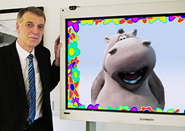 Photograph of Ian Bean with an interactive plasma screen